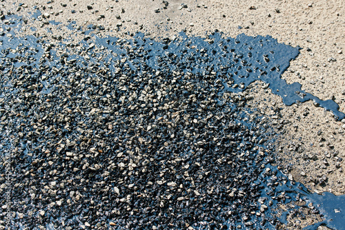 Obraz na płótnie Resincoat asphalt crack repair. Road work in progress showing close view of resin coat filling cracks and asphalt patches sealing damaged street surface to prevent further pavement deterioration w salonie