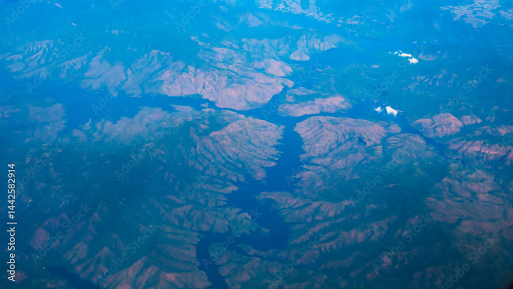 Fototapeta premium Aerial view from window airplane sky summer tropical blue sky fluffy white cloud summertime on light sunny day cloudscape ocean seascape. Clear bright blue skyline spring sunlight climate background