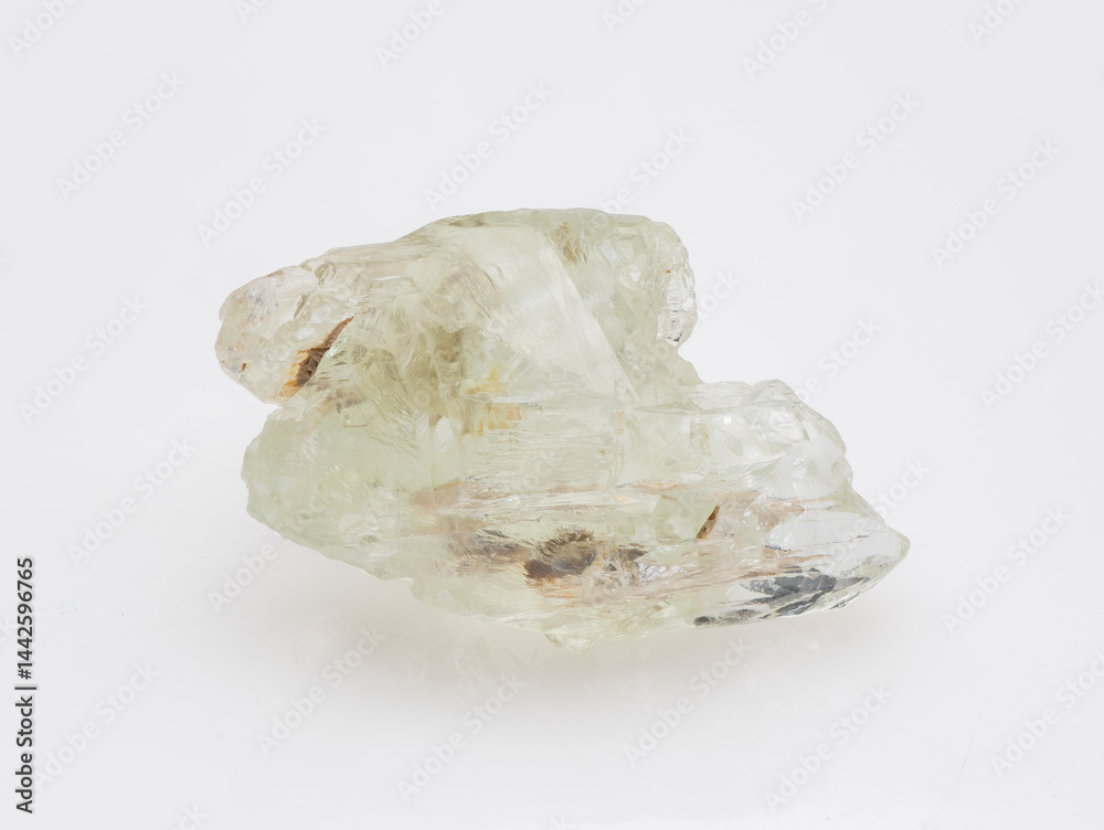 A raw, uncut specimen of pale green beryl crystal showcased against a clean, neutral background, highlighting its natural formations and internal inclusions mineralogy, geology, transparency
