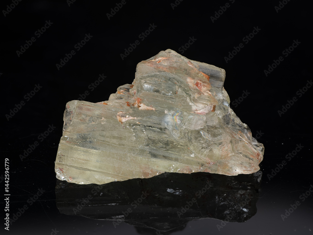 Exceptional Transparent Beryl Crystal Specimen on Reflective Black Surface Showcasing Natural Inclusions A Light Yellowish-White Beryl Formation, Exhibiting Cleavage Planes and Internal Fractures