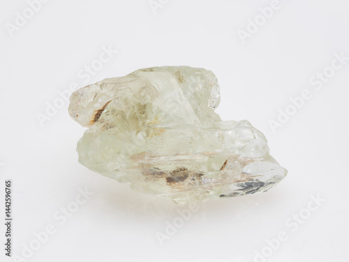 Obraz na płótnie A raw, uncut specimen of pale green beryl crystal showcased against a clean, neutral background, highlighting its natural formations and internal inclusions mineralogy, geology, transparency w salonie