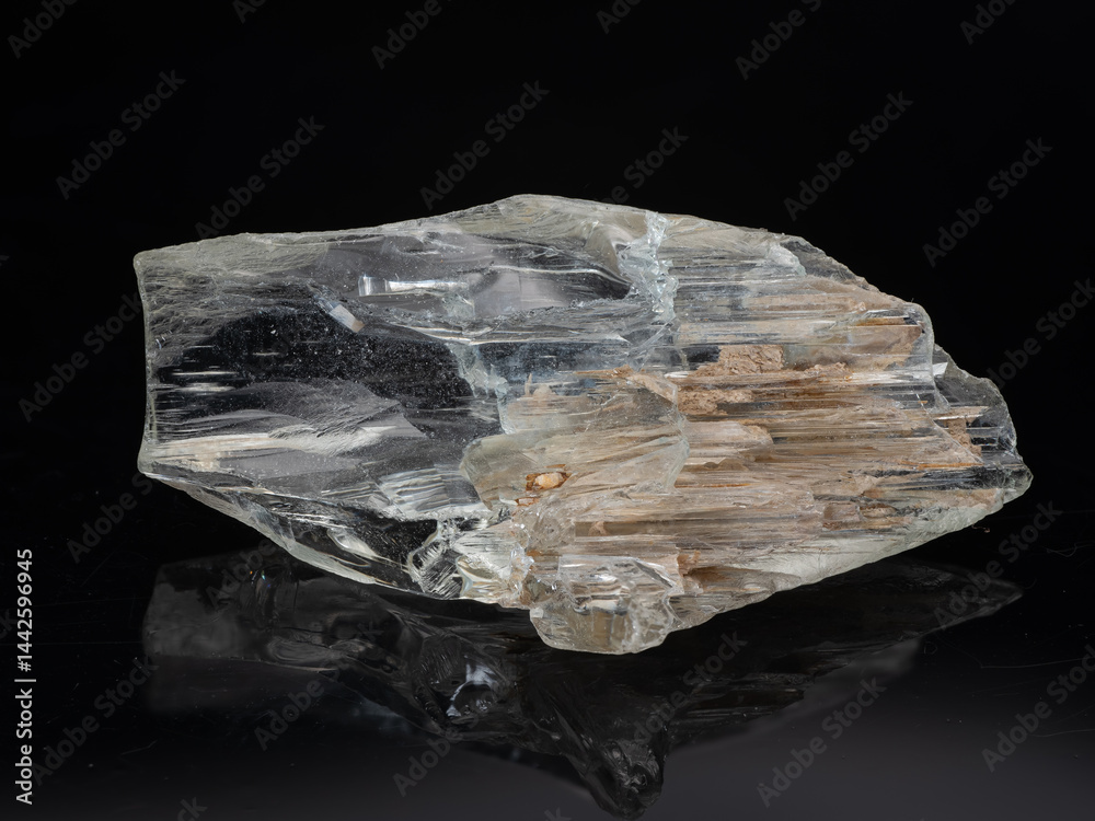 A captivating raw beryl crystal specimen highlighted against a black backdrop, showcasing its translucent, pale grey to clear structure with visible internal inclusion and subtle striations