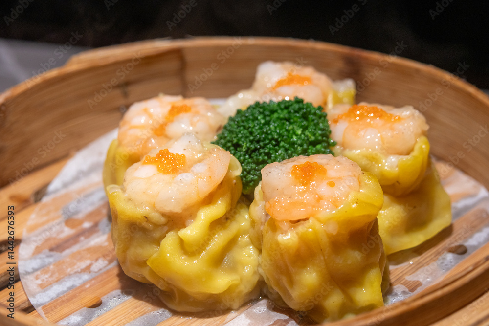 Chinese steamed pork dumplings, Siu Mai, in bamboo steamers