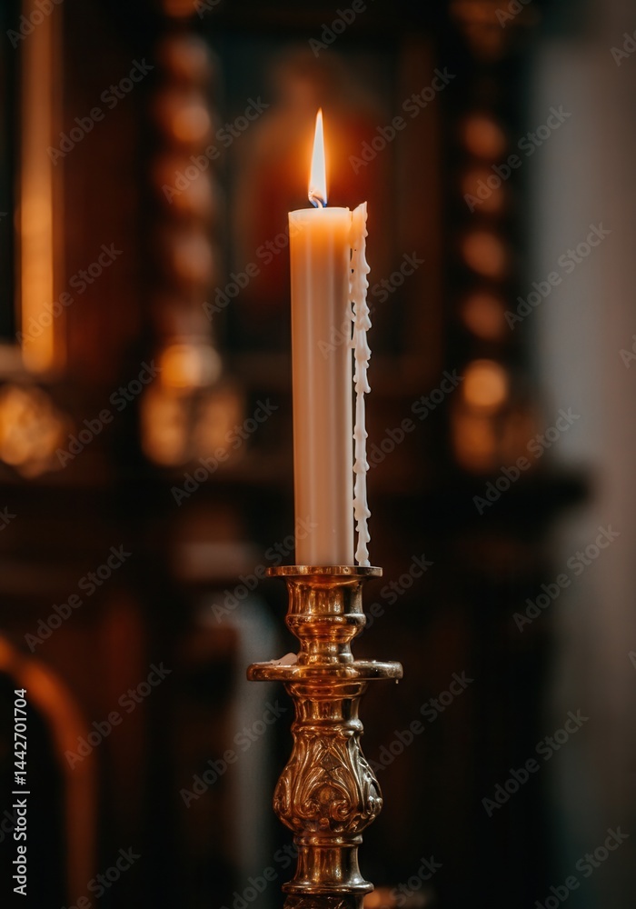 Burning white candle on ornate golden candlestick with blurred historic church interior in background, symbolizing guidance and hope during the papal conclave
