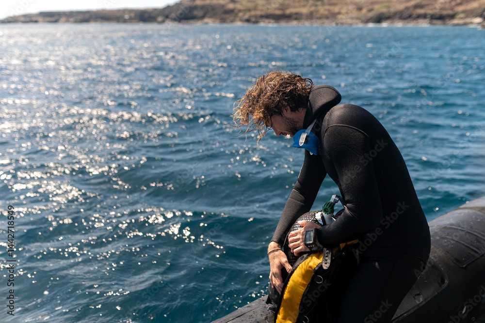 Obraz premium Diver checking scuba equipment on boat before diving in the sea