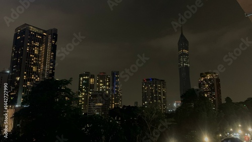 Photography Landscape view of Kuala Lumpur night city view featuring the tall Merdeka 118 tower and surrounding lit-up buildings, capturing the skyline, city lights, and modern high-rise architecture of Malaysia