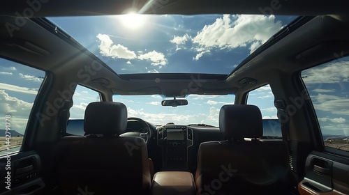 Vehicle interior view of panoramic roof and sky