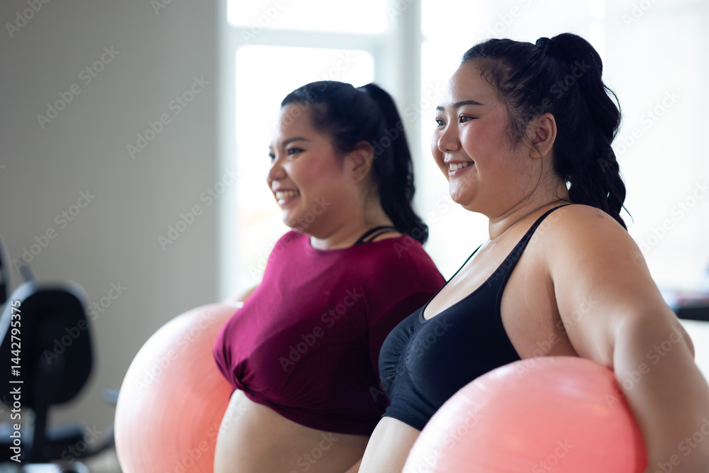 gymnastic ball. beautiful young chubby overweight woman in sportswear doing exercise indoors at gym fitness sport club, body and health care