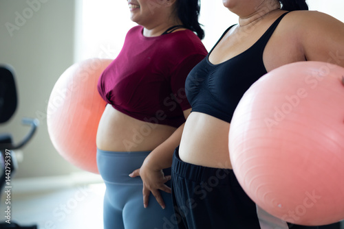 Obraz na płótnie gymnastic ball. beautiful young chubby overweight woman in sportswear doing exercise indoors at gym fitness sport club, body and health care w salonie