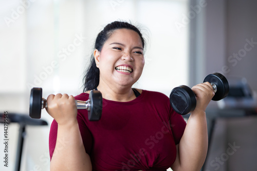 Obraz na płótnie Portrait woman Exercise. beautiful young chubby overweight woman wearing sporty fitness clothes doing exercise indoors at gym fitness sport club, body and health care w salonie