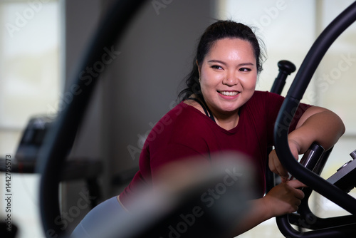 Obraz na płótnie Portrait woman Exercise. beautiful young chubby overweight woman wearing sporty fitness clothes doing exercise indoors at gym fitness sport club, body and health care w salonie