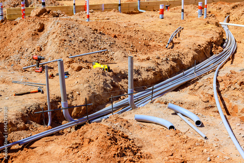 Canvas Print Workers are installing electrical piping at construction site, showcasing ground