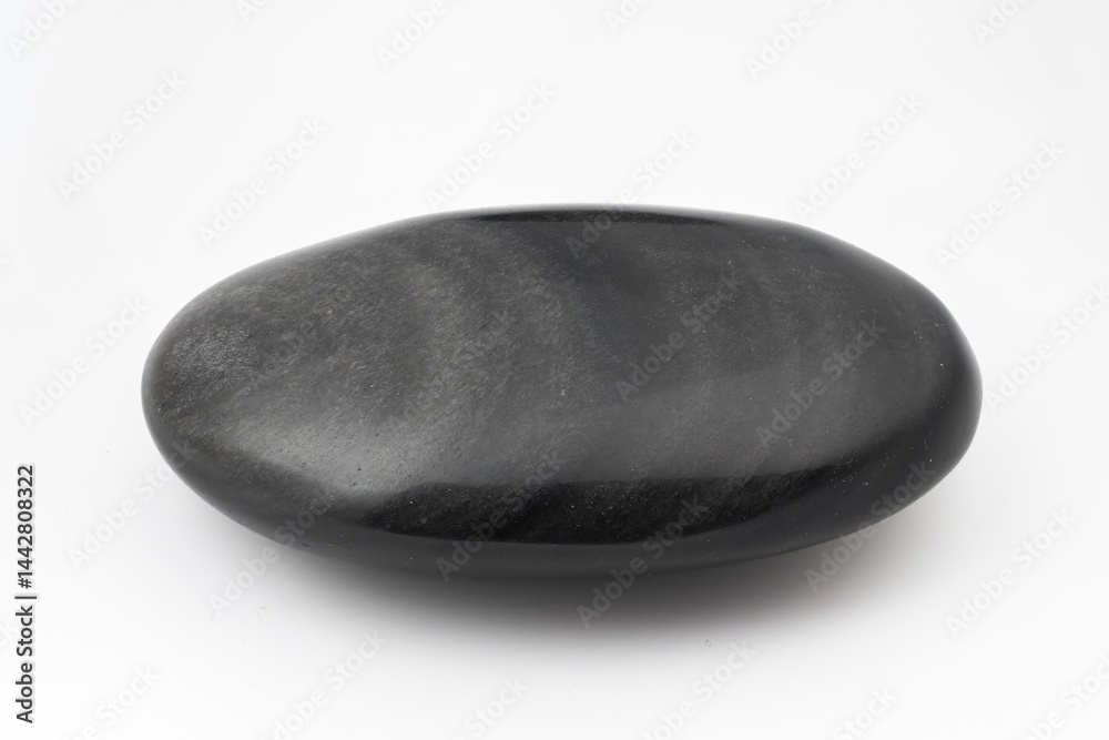 Polished black snow obsidian stone isolated on white background, smooth rounded pebble, mineral specimen