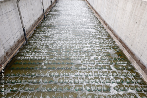 Biological treatment process in aeration basin closeup. Specialized equipment serves for breakdown of organic pollutants by infusion of oxygen