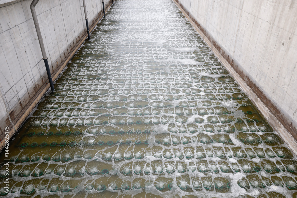 Biological treatment process in aeration basin closeup. Specialized equipment serves for breakdown of organic pollutants by infusion of oxygen