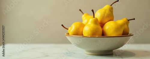 A ceramic bowl brimming with shiny, ripe golden pears, shiny, natural