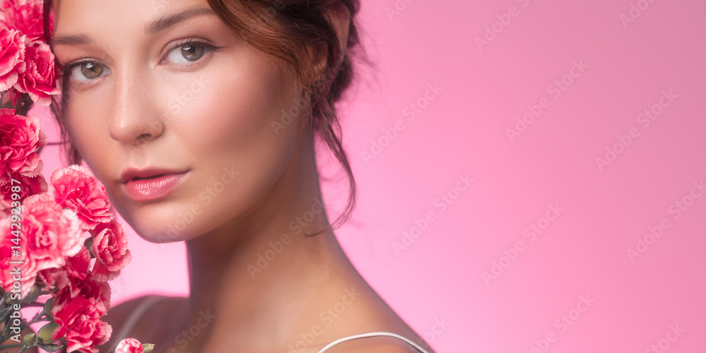 Elegant horizontal banner showing a beautiful woman posing with fresh pink carnations and glowing skin. Ideal for floral-themed beauty ads, skincare promotions, and cosmetic product branding.