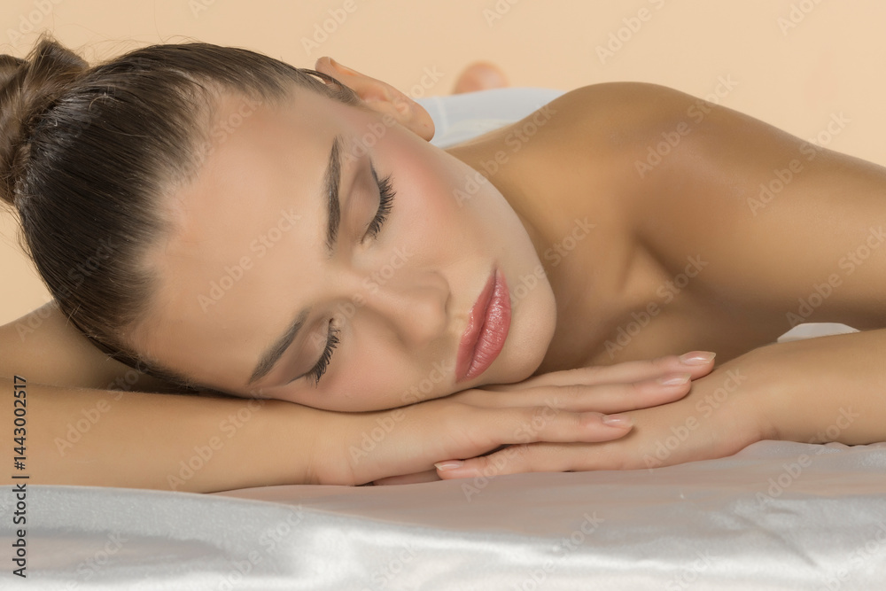 Peaceful spa scene with model resting during professional massage treatment, embodying relaxation and wellness Peaceful spa scene with model resting during professional massage treatment, embodying relaxation and wellness