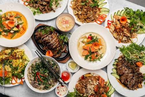 assortment of mixed traditional vietnamese food dishes on buffet table