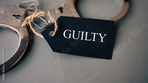 Handcuffs with a tag written 'Guilty'