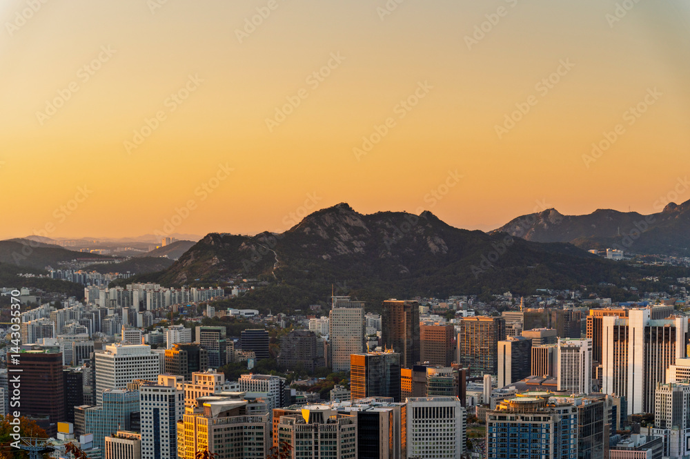 Gold sun risae or sunset of Seoul cityscapes with high rise office buildings and skyscrapers in Seoul city, Republic of Korea in winter season