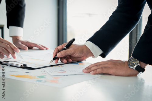 Team meeting focused on planning, strategy with data analysis for business growth financial feasibility fostering teamwork and organizational clarity.