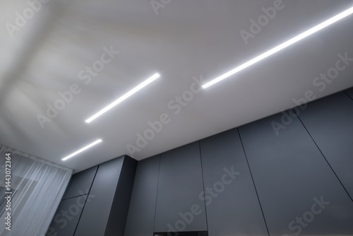 Obraz na płótnie suspended ceiling with halogen spots lamps in form of squares and rectangles and drywall construction in empty room in apartment or house. Stretch ceiling white and complex shape. w salonie
