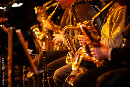 Big Band Saxophones. A view across the sax section in a big band performing together live on stage. photo