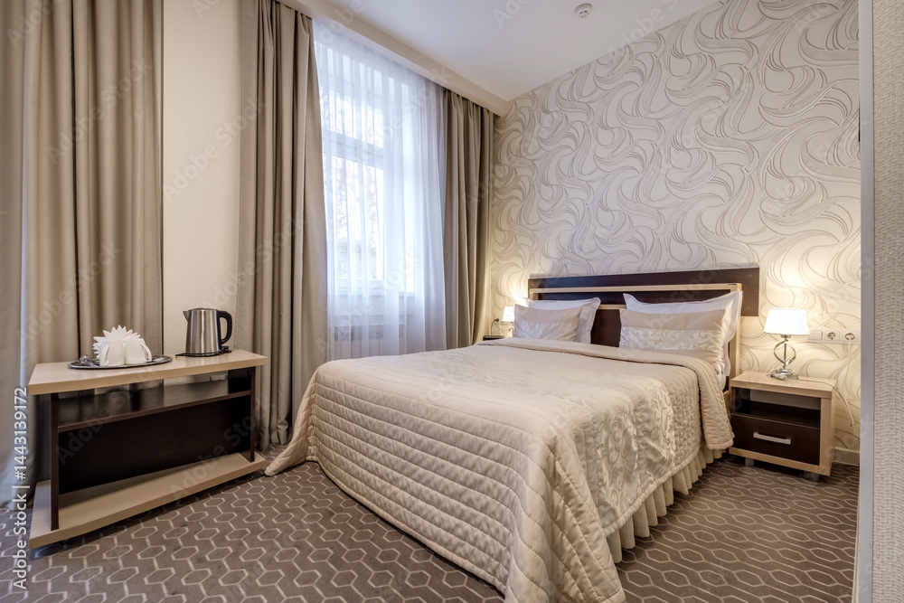 Interior of modern luxure bedroom in studio apartments with double bed with pillows