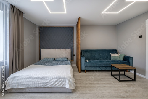Interior of modern luxure bedroom in studio apartments with double bed with pillows