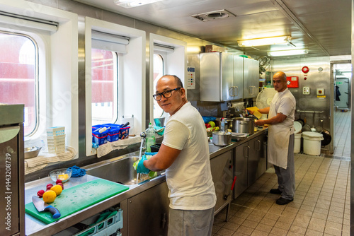 Фотография Ship's cook at work in the galley of a merchant vessel - focused, skilled, and essential to daily life at sea