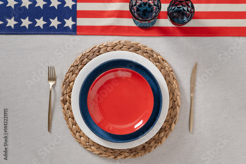 Obraz na płótnie Patriotic table setting for USA Independence Day. Festive dinner with empty red plate and decoration in USA national flag colors white, red and blue. View from above. Copy space. w salonie