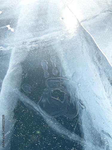 Frozen handprint on lake baikal ice in winter