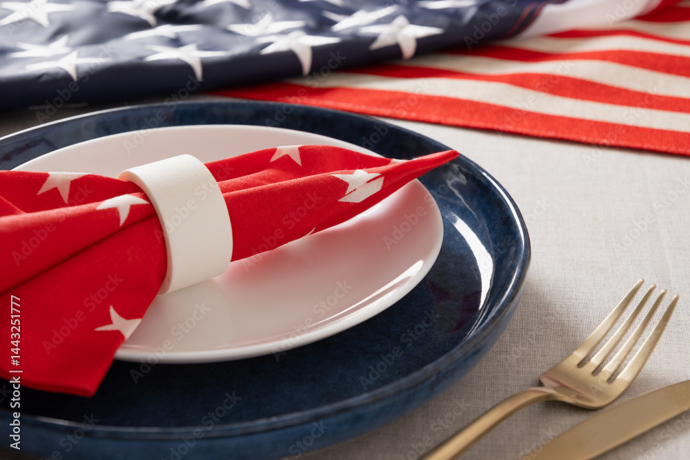 American table setting for USA Independence Day. Festive dinner decorated in USA national flag colors white, red and blue. Close up.