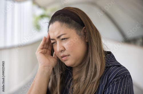 Unwell middle age woman having migraine type headache, pain at one side of the head problem, concept image for physical and mental health care