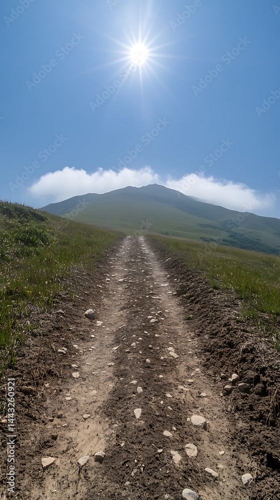 Mountain path ascends towards sun