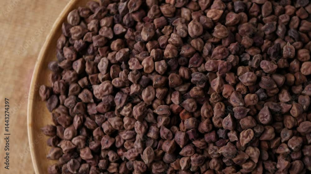 Raw Dark Brown Chickpeas (Kala Chana) on a rustic wooden table. Dry Balck chickpea (ceci neri) background close up. Raw Dark Brown Chickpeas (Kala Chana) on a rustic wooden table. Dry Balck chickpea (ceci neri) background close up.