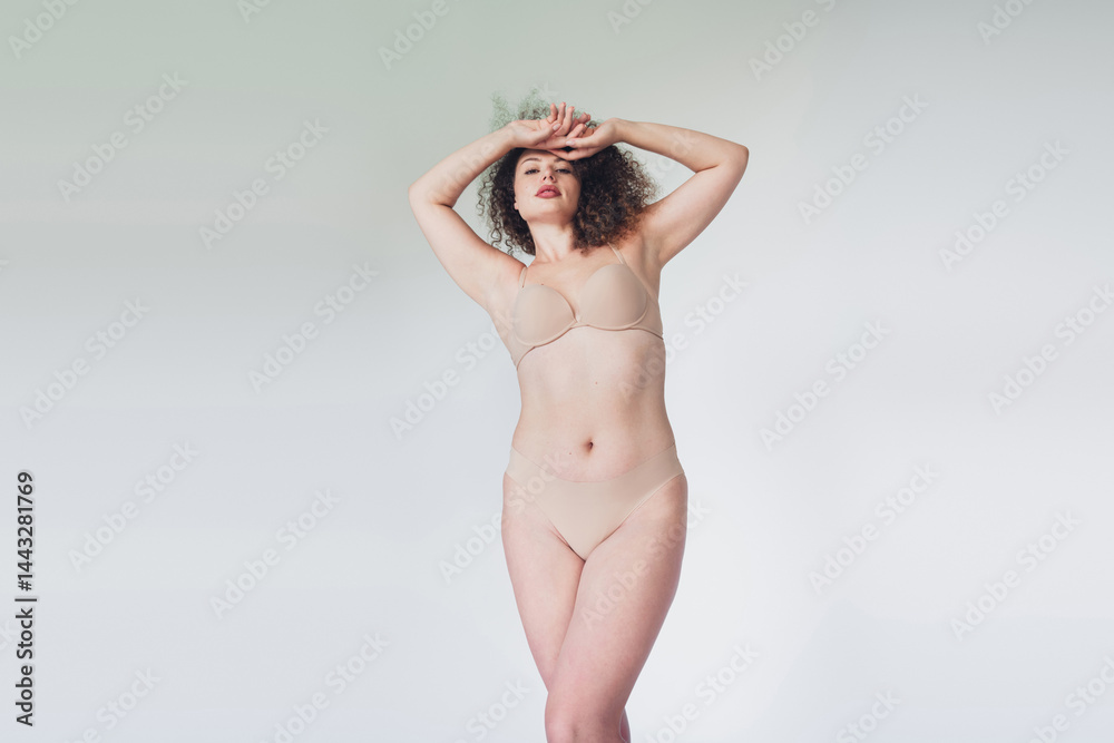 Fototapeta premium Confident woman embracing natural beauty in beige lingerie, celebrating body positivity and self acceptance Sensual
