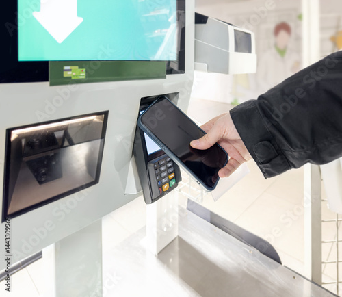 Customer pays his purchase at the supermarket,self checkout systems in  retail stores,Barcode scanner,Self checkout machine