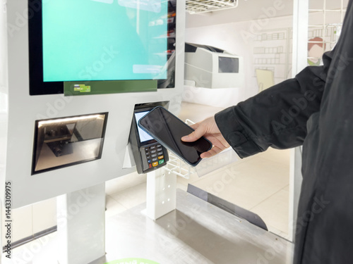 Customer pays his purchase at the supermarket,self checkout systems in  retail stores,Barcode scanner,Self checkout machine