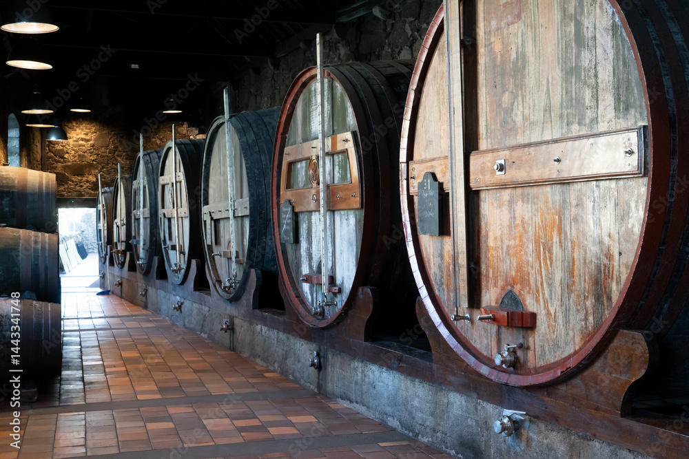 Wine cellar, row of wooden barrels