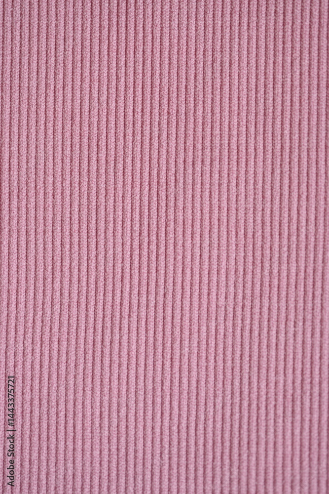 Fototapeta premium pink texture of knitted synthetic fabric as a background, pink smooth symmetrical lines of synthetic fabric 