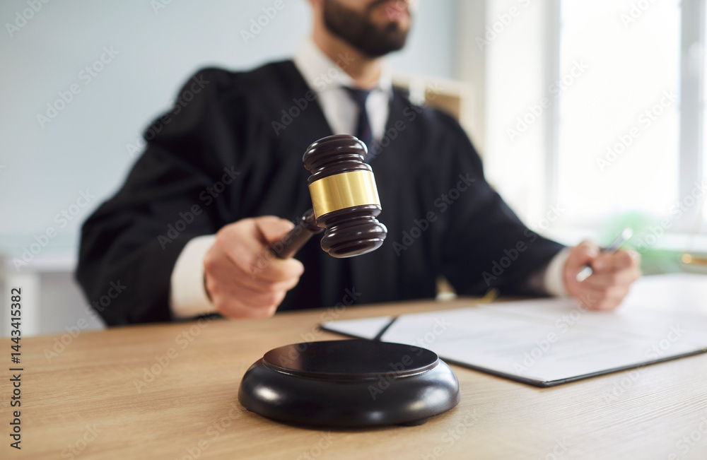 Close up shot of a court judge in courtroom uses gavel to deliver judgment or verdict in legal case, focusing on law and criminal proceedings in a professional setting with authority and precision.