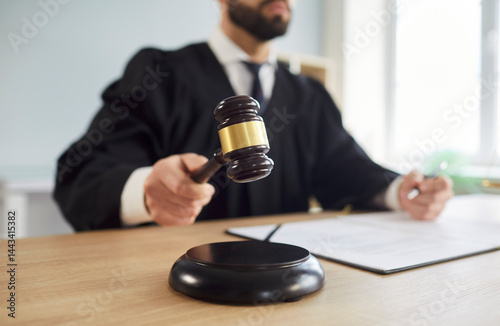 Obraz na płótnie Close up shot of a court judge in courtroom uses gavel to deliver judgment or verdict in legal case, focusing on law and criminal proceedings in a professional setting with authority and precision. w salonie