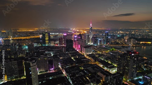 Aerial drone view of large city lighting up at nightfall with risk of power blackout. Symbolizes modern lighting, power grid dependency,  light pollution concept