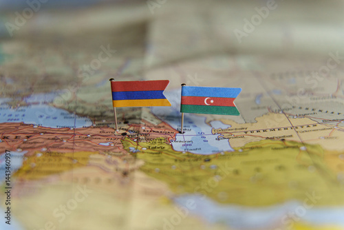 Mini flags of Armenia and Azerbaijan pinned on a map, symbolizing political tension and conflict over borders