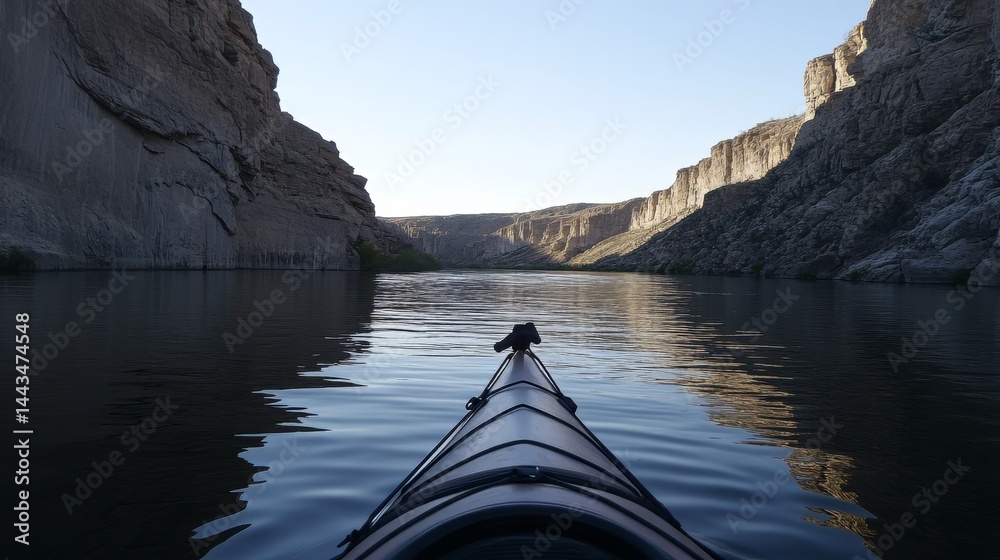 Fototapeta premium A yellow kayak is in the water. The kayak is in the middle of a river