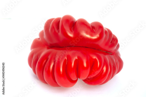 A large red tomato on a white background of unusual shape. High quality photo