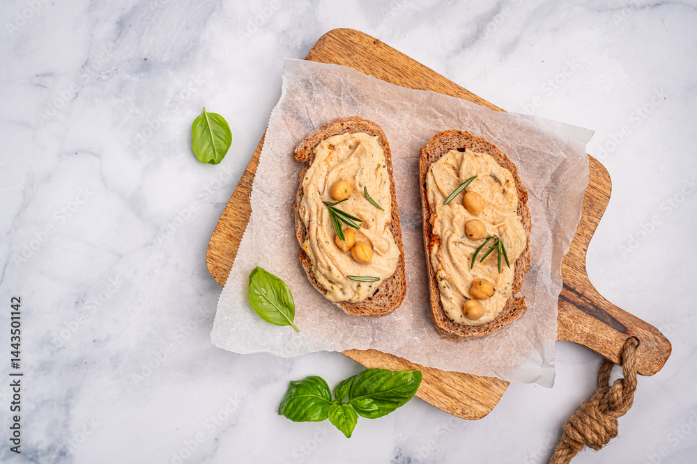 Delicious sandwiches with hummus and ingredients on white table, top view, flat lay. High quality photo