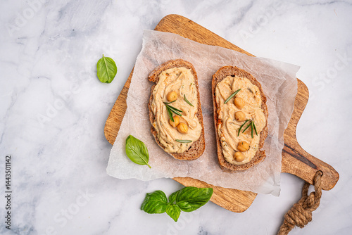 Obraz na płótnie Delicious sandwiches with hummus and ingredients on white table, top view, flat lay. High quality photo w salonie